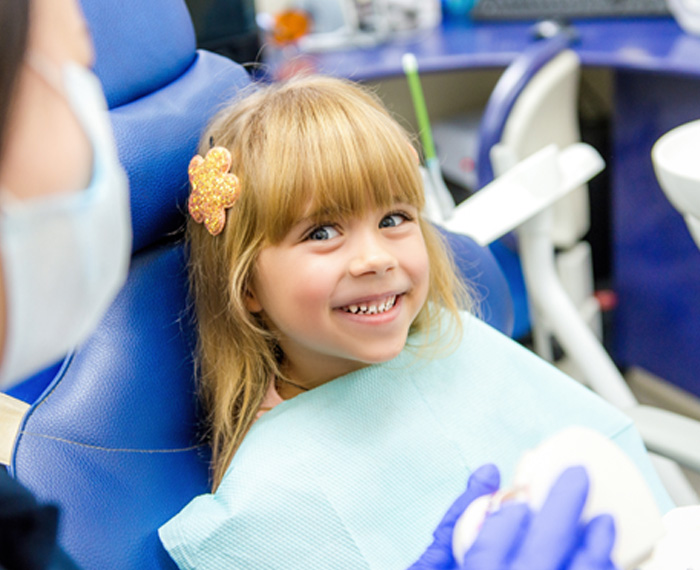 Patient in Pleasanton with lip and tongue-ties talking to dentist